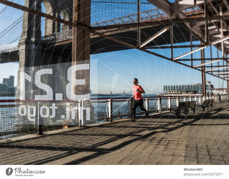 USA, New York City, man running at East River with data emerging from smartwatch men males smart watch Adults grown-ups grownups adult people persons