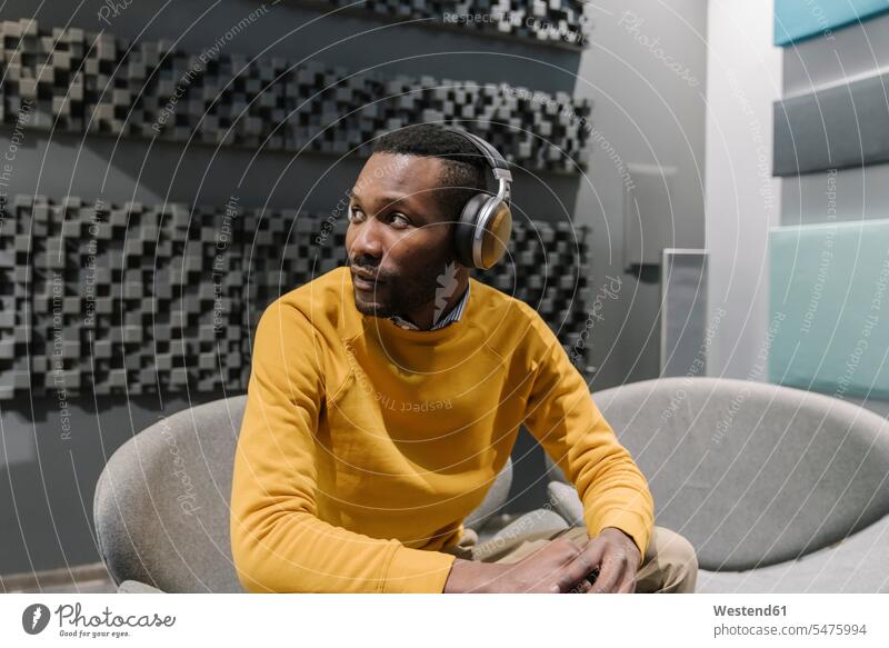 Portrait of a man with headphones looking around human human being human beings humans person persons African black black ethnicity coloured 1 one person only