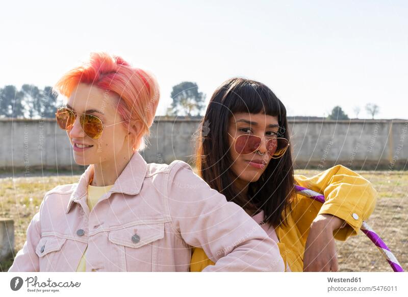 Two alternative friends wearing yellow and pink jeans jackets female friends equality Alternative homosexual queer same-sex homosexually gay homosexual woman