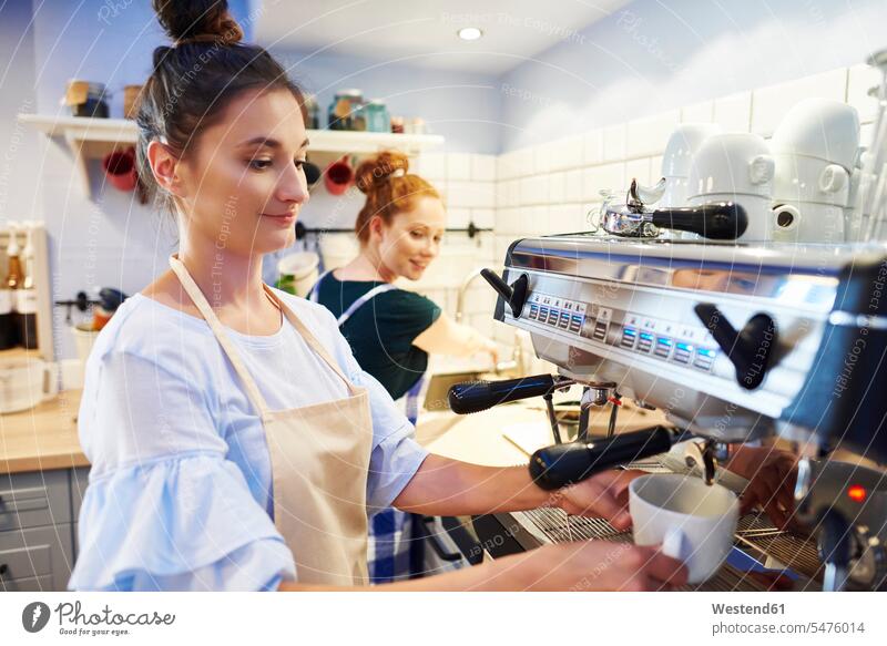 Female barista making coffee at a cafe Barista Baristas Coffee Machine Coffee Maker Coffee Machines Coffee Makers working At Work woman females women automat