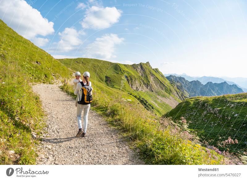Germany, Bavaria, Oberstdorf, mother and little daughter on a hiking trip in the mountains mommy mothers mummy mama hike daughters parents family families