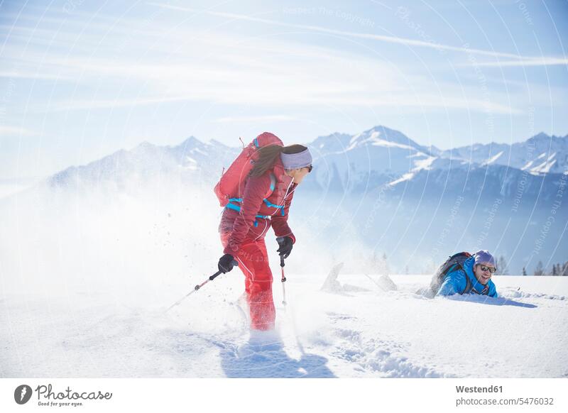 Austria, Tyrol, snowshoe hikers running through snow, man falling snowshoeing couple twosomes partnership couples winter hibernal tumbling tumble winter sport