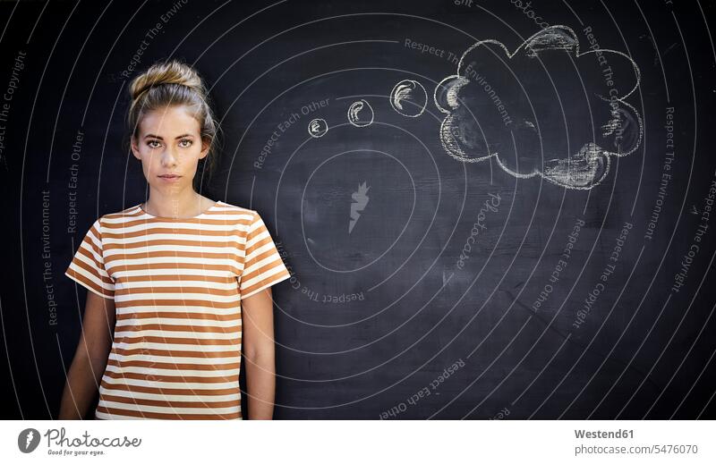 Pensive young woman standing in front of a blackboard next to a thought bubble blackboards T- Shirt t-shirts tee-shirt contemplative Reflective thoughtful