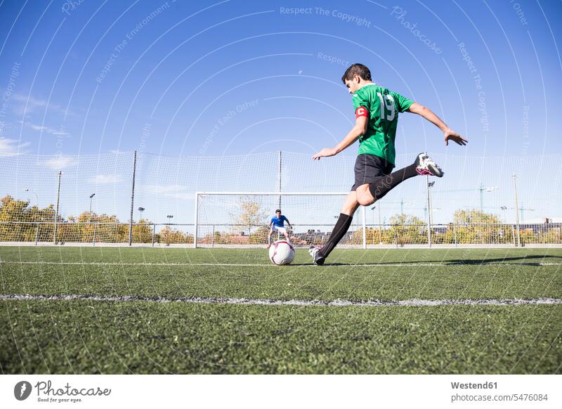 Football player shooting the ball on football field balls football ground soccer pitch football pitch football player footballers football players