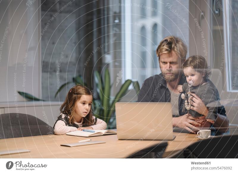 Casual businessman with two daughters working at desk in office Occupation Work job jobs profession professional occupation business life business world