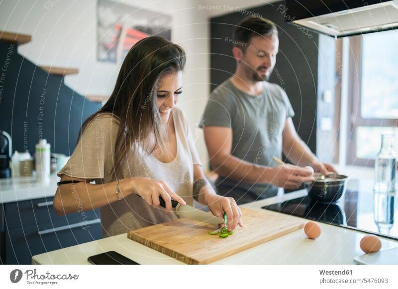 Couple preparing food on kitchen island at home color image colour image Spain indoors indoor shot indoor shots interior interior view Interiors Home Interior