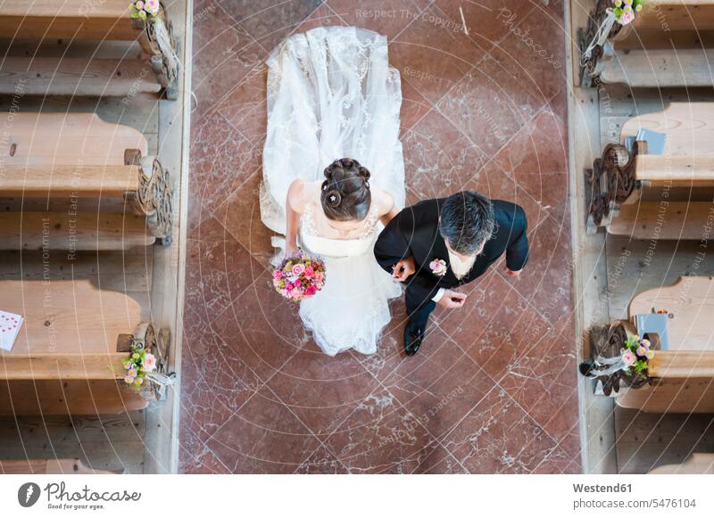 Newlywed couple walking on tiled floor in church color image colour image Germany Life Events Lifetime Event indoors indoor shot indoor shots interior