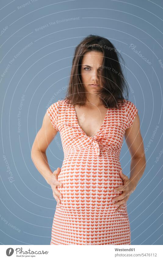 Woman pretending to be pregnant, looking angry touching stroking petting mid adult women mid adult woman mid-adult women mid-adult woman Pregnant Woman fat