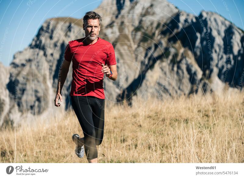 Austria, Tyrol, man running in the mountains mountain range mountain ranges men males landscape landscapes scenery terrain mountainscape mountainscapes