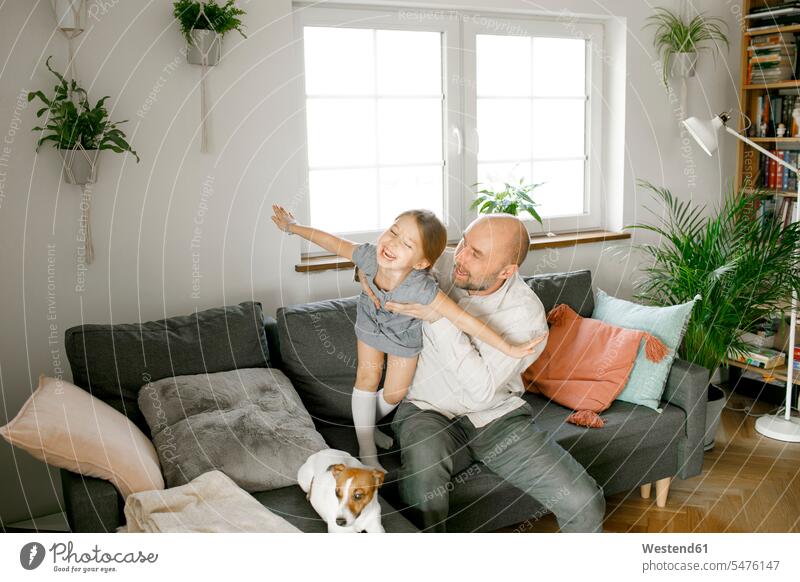 Father and laughing daughter playing at home human human being human beings humans person persons caucasian appearance caucasian ethnicity european 2 2 people