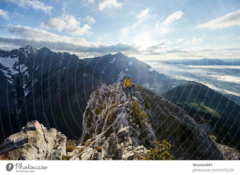 Austria, Tyrol, Gnadenwald, Hundskopf, male climber standing on rock in the morning light Adventure adventurous Adventures extreme sports mountaineering