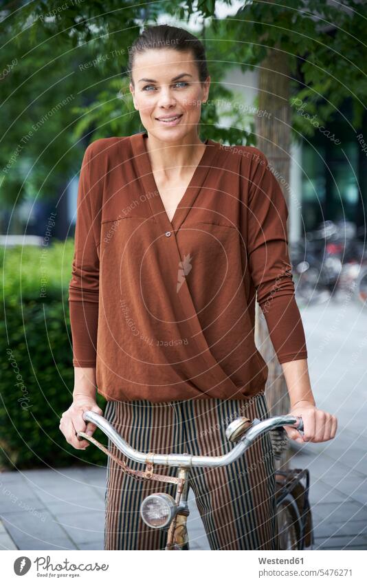 Portrait of woman with bicycle in the city business life business world business person businesspeople business woman business women businesswomen bikes cycles