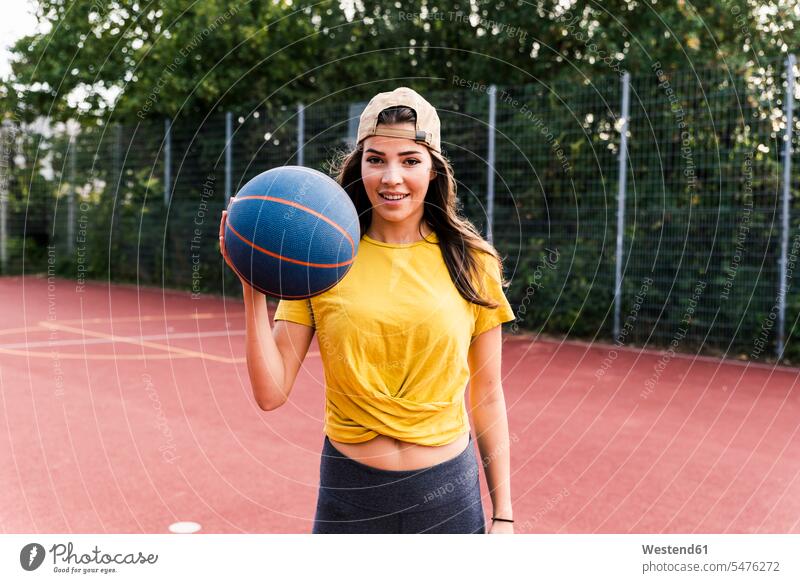 Happy young woman playing basketball balls exercising exercise training practising holding fitness active happiness happy sport young women Basketball sports
