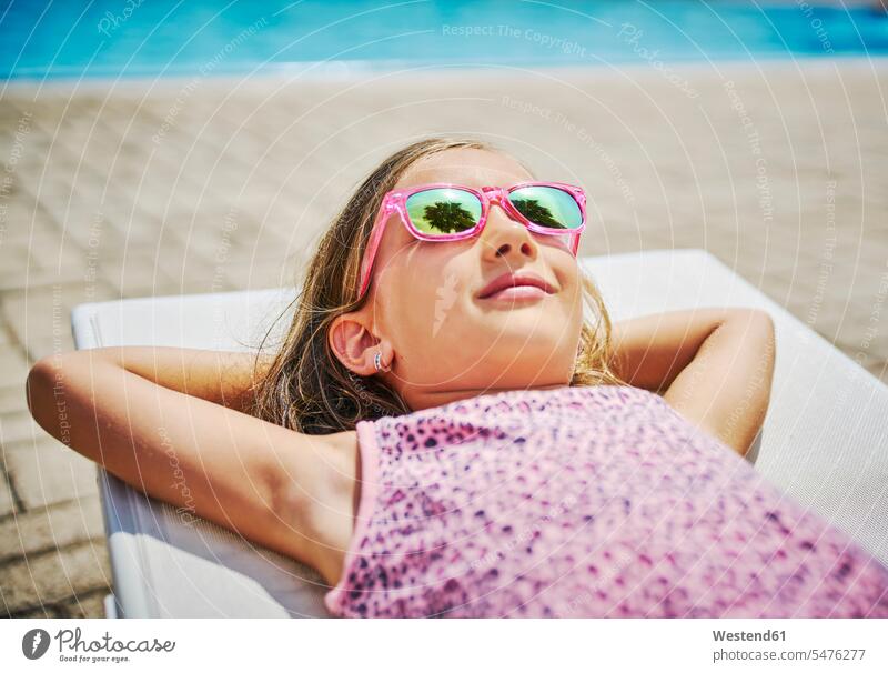 Girl with sunglasses lying at the poolside sun glasses Pair Of Sunglasses swimming pool swimming pools pool edge Pool Side laying down lie lying down girl