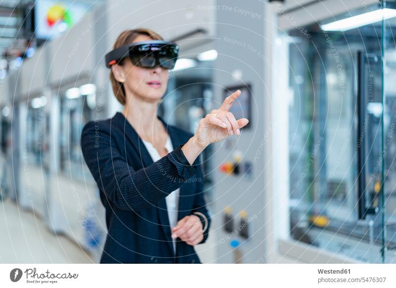 Businesswoman wearing AR glasses in a modern factory Occupation Work job jobs profession professional occupation business life business world business person