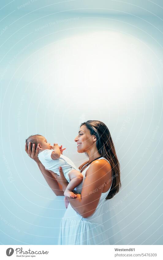 Smiling mother holding her baby boy indoors human human being human beings humans person persons caucasian appearance caucasian ethnicity european 2 2 people