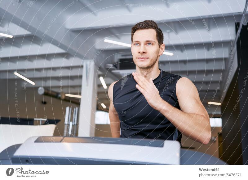 Portrait of man running on treadmill at gym Treadmills running machine gyms Health Club portrait portraits exercise equipment Exercising Equipment