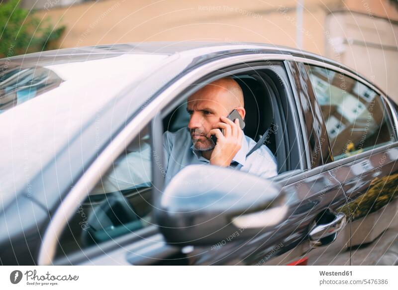Businessman driving vehicle and using smartphone human human being human beings humans person persons caucasian appearance caucasian ethnicity european 1