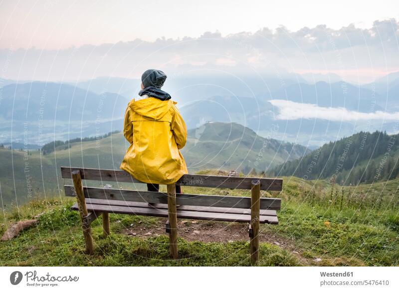 Austria, Tyrol, Fieberbrunn, Wildseeloder, woman sitting on bench with view on mountainscape View Vista Look-Out outlook benches mountainscapes mountain scenery