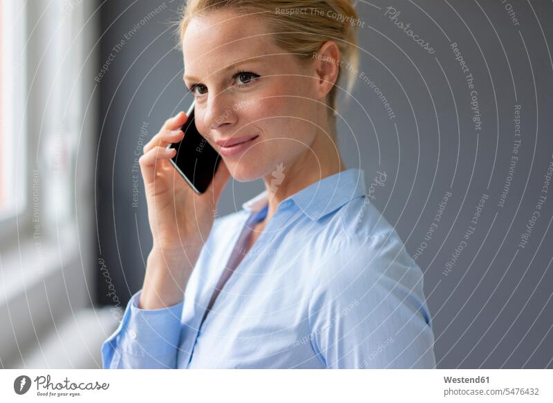 Young businesswoman talking on cell phone in office business life business world business person businesspeople business woman business women businesswomen