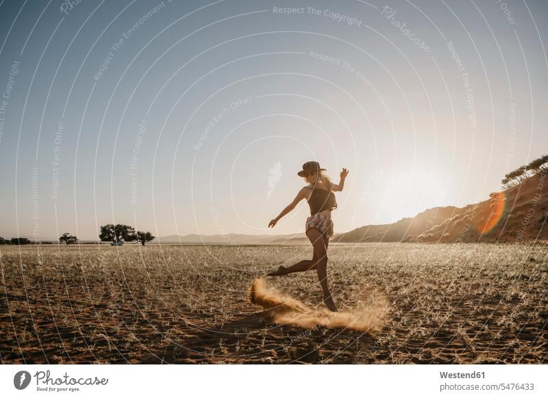 Namibia, Namib desert, Namib-Naukluft National Park, Sossusvlei, woman moving at sunset at Elim Dune move females women sunsets sundown dune dunes Adults