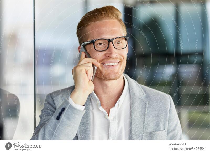 Portrait of smiling redheaded businessman on cell phone smile Businessman Business man Businessmen Business men mobile phone mobiles mobile phones Cellphone