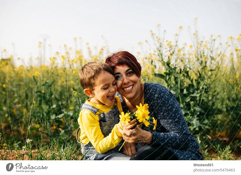 Portrait of happy mother with little son in nature happiness natural world sons manchild manchildren family families people persons human being humans