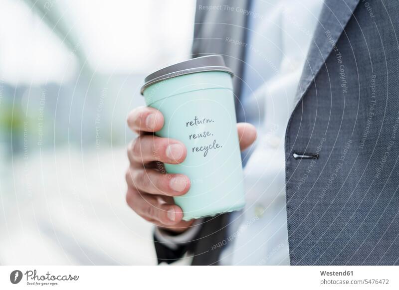 Close-up of businessman holding recycable takeaway coffee cup caucasian caucasian ethnicity caucasian appearance european urban urbanity environment ecology