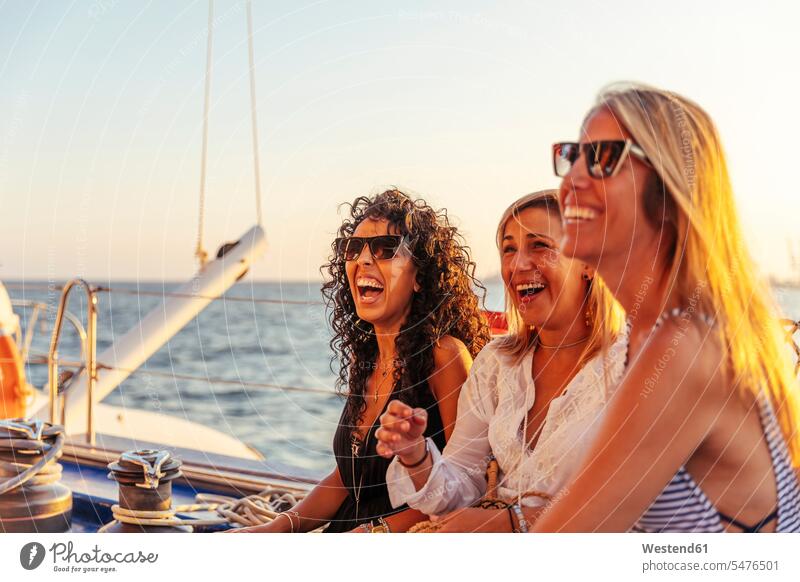 Friends laughing during boat trip in the evening light human human being human beings humans person persons caucasian appearance caucasian ethnicity european