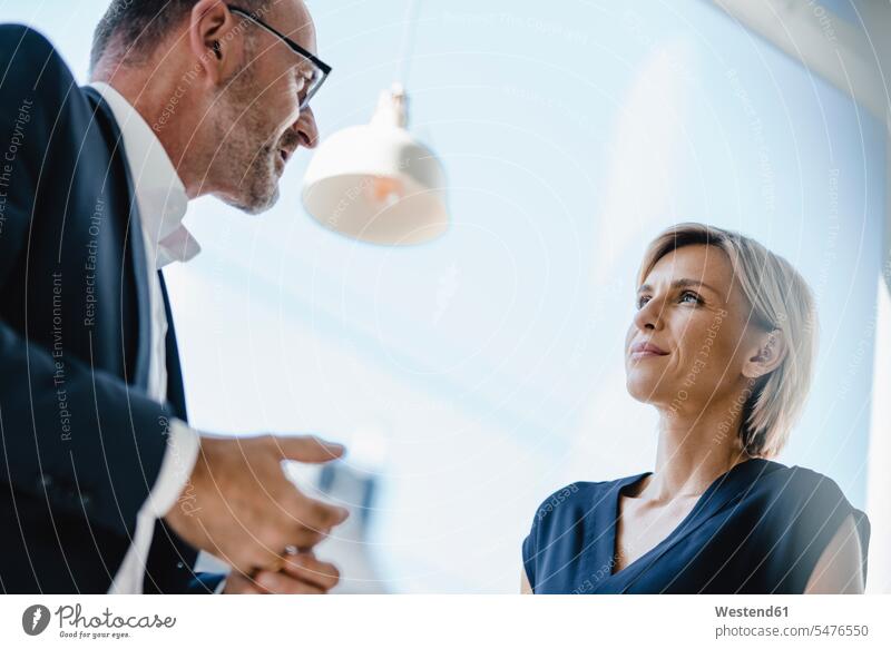 Businessman and woman talking about solutions human human being human beings humans person persons caucasian appearance caucasian ethnicity european 2 2 people