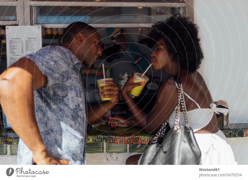 Young couple having a drink at a kiosk Drink beverages Drinks Beverage drinking twosomes partnership couples food and drink Nutrition Alimentation
