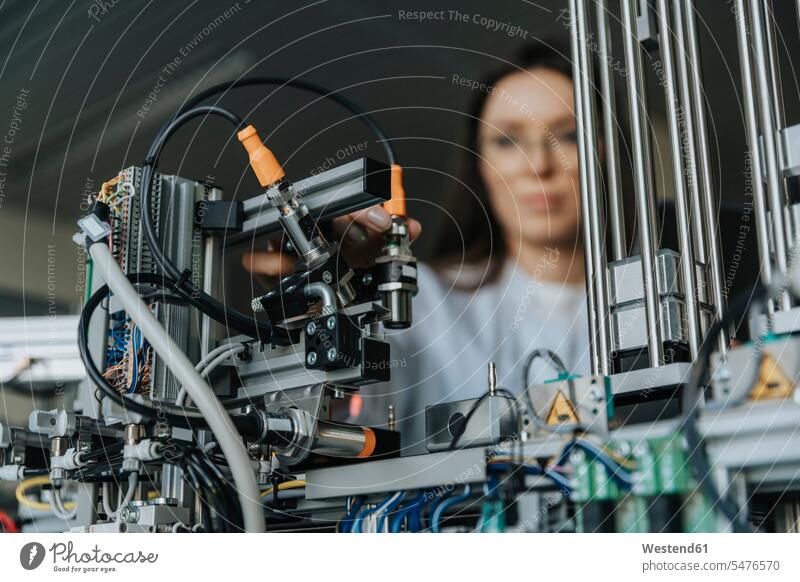 Close-up of female scientist examining machinery in laboratory color image colour image indoors indoor shot indoor shots interior interior view Interiors
