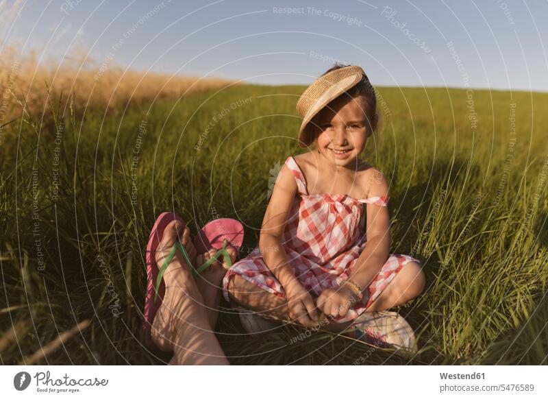 Smiling girl sitting with mother on land against clear sky at sunset color image colour image Germany leisure activity leisure activities free time leisure time