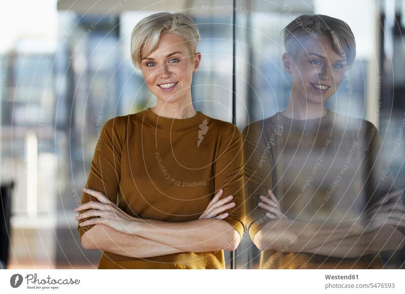 Portrait of smiling woman leaning against window females women portrait portraits smile windows Adults grown-ups grownups adult people persons human being