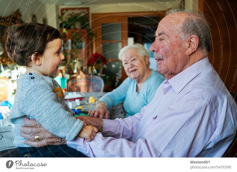Great-grandparents playing with baby girl at home great-grandparents infants nurselings babies baby girls female family families people persons human being