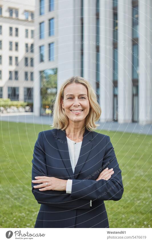 Portrait of confident businesswoman standing on lawn in the city Occupation Work job jobs profession professional occupation business life business world