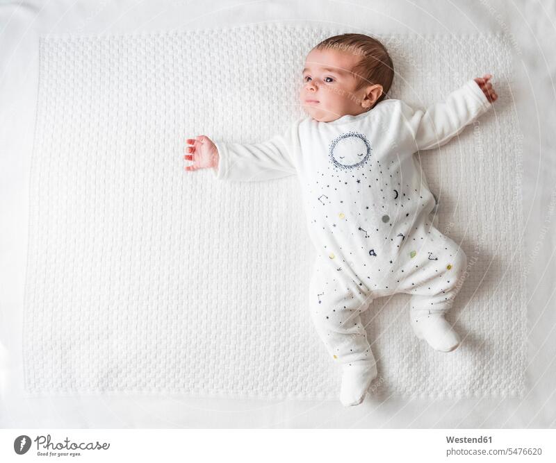 Baby boy laying in bed over white blanket indoor indoor shot indoor shots interior interior view Interiors beds High Angle Shot High Angle View from above