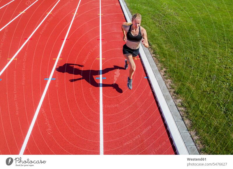 Athletic sports, female sprinter exercising exercise training practising runner runners athlete sportswoman athletes female athlete sportswomen female athletes