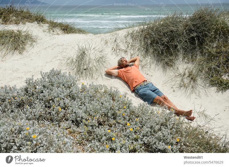 South Africa, man lying at Bloubergstrand alone solitary solo Taking a Break resting break men males barefoot naked feet naked foot Barefeet Bare Feet Bare Foot