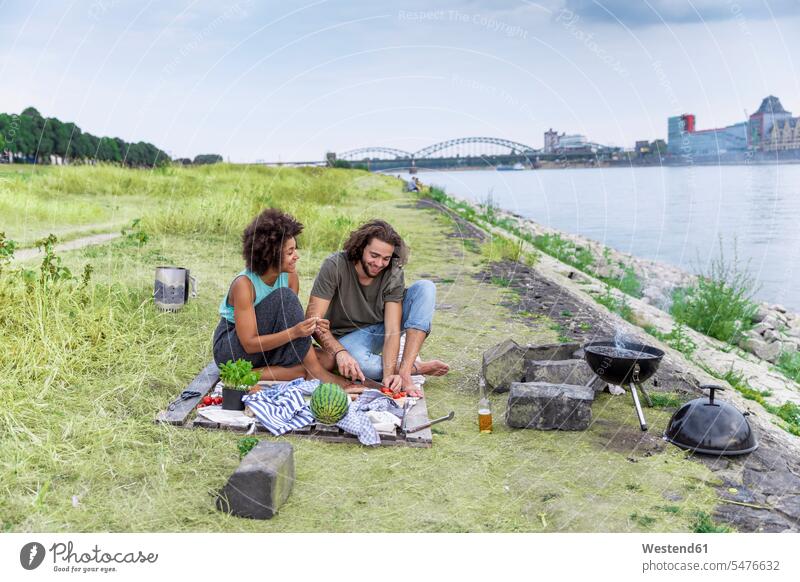 Germany, Cologne, couple having a barbecue at the riverside Barbecue BBQ Barbeque riverbank twosomes partnership couples water's edge waterside shore people