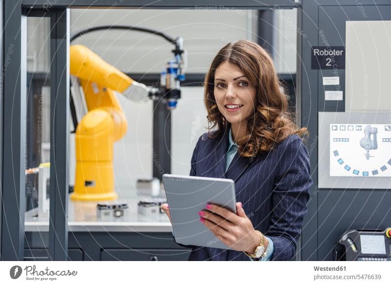 Businesswoman, working in high tech company, using digital tablet industry industrial robot robots businesswoman businesswomen business woman business women