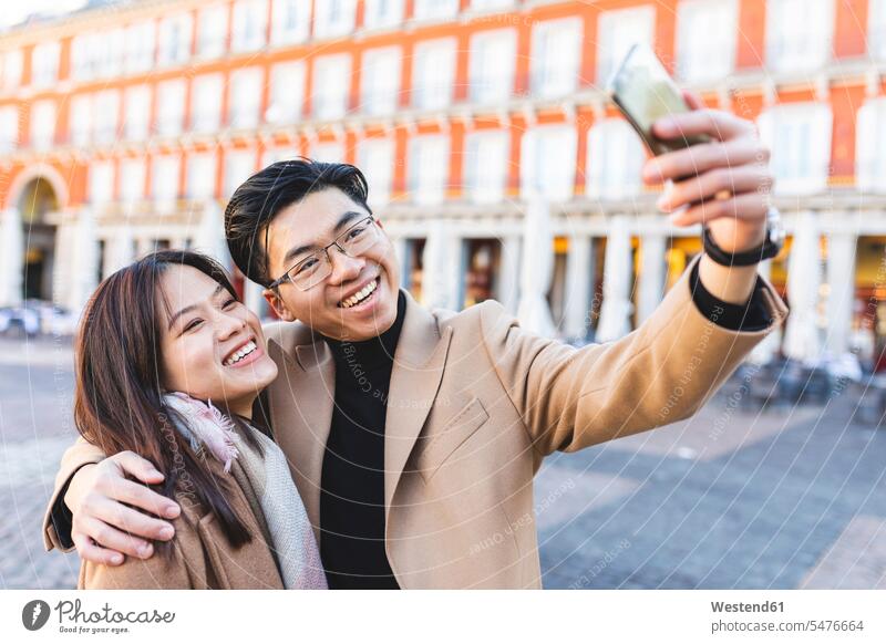 Spain, Madrid, happy young couple taking a selfie in the city town cities towns Selfie Selfies happiness twosomes partnership couples outdoors outdoor shots
