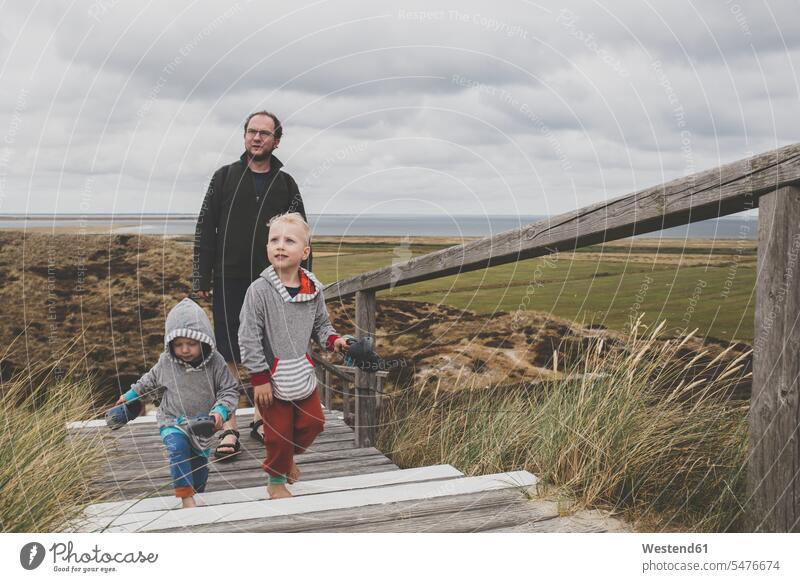 Father and his children walking up stairs among the dunes, Sylt, Germany human human being human beings humans person persons caucasian appearance