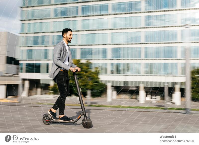 Casual young businessman riding electric scooter in the city business life business world business person businesspeople Business man Business men Businessmen