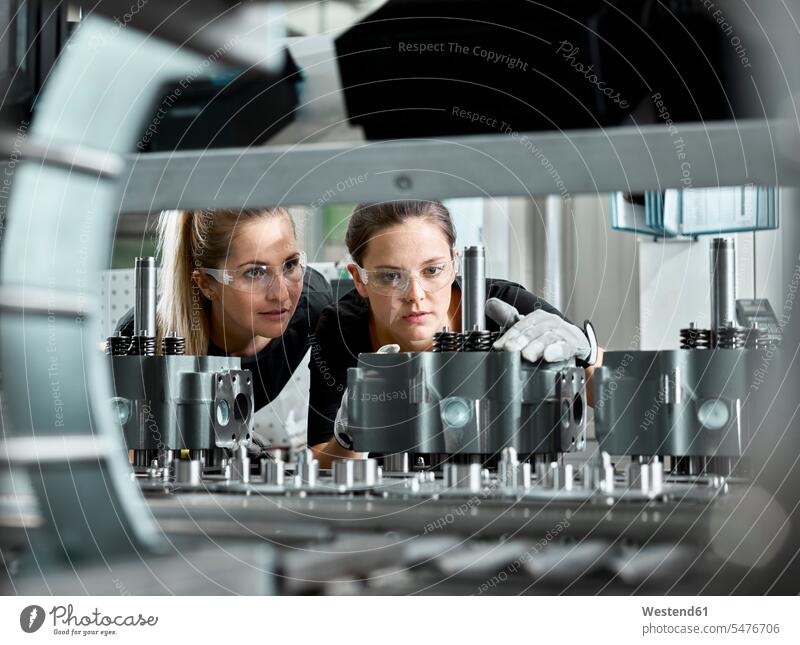 Young women checking production line on a conveyor belt scrutiny scrutinising scrutinise scrutinizing scrutinize safety glasses Protective Eyeglasses