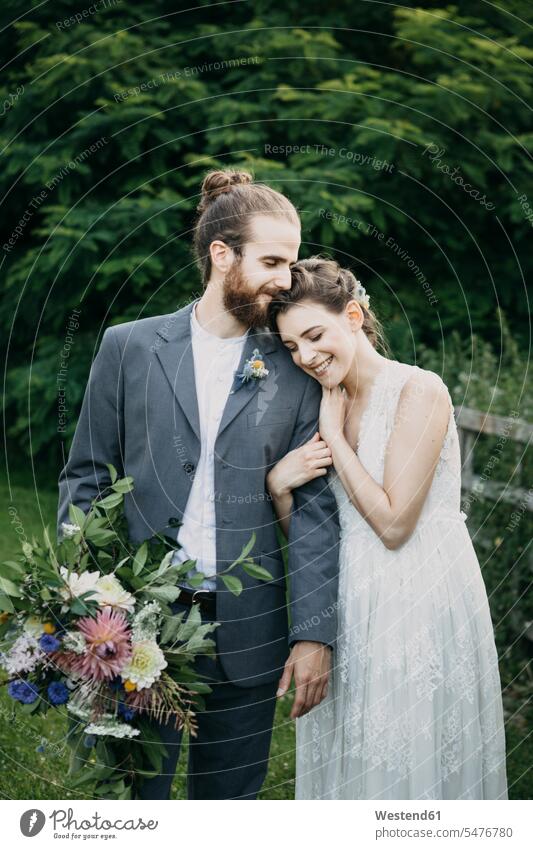 Happy affectionate bride and groom standing on a meadow brides Affection Affectionate meadows happiness happy bridal couple bridal couples bridegrooms Wedding