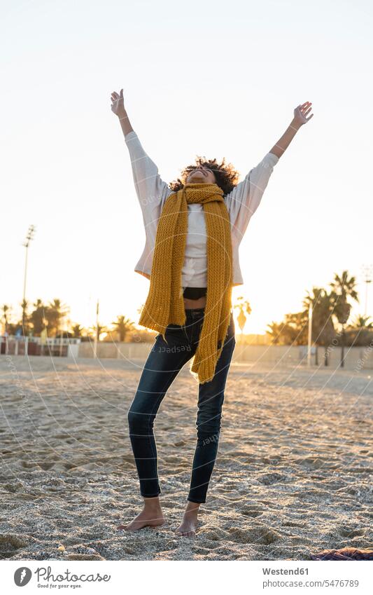 Happy woman having fun on the beach at sunset Fun funny stretching dancing dance raising arms arm up Hands Raised arm raised Hands Up arms up Hand Up