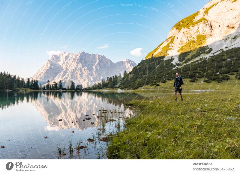 Austria, Tyrol, Hiker with backpack, hiking at Lake Seebensee hiker wanderers hikers lake lakes rucksacks backpacks back-packs water waters body of water