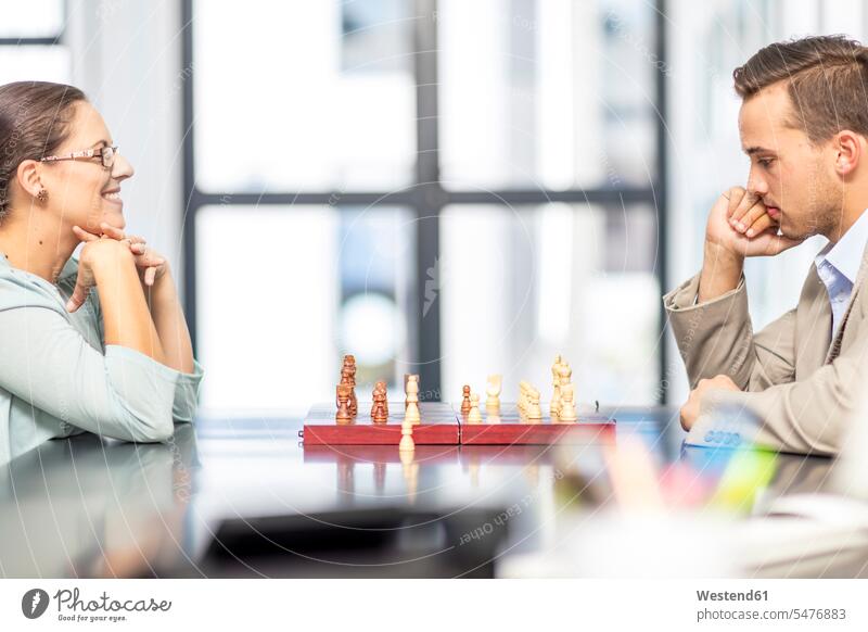 Businesswoman and businessman playing chess Businessman Business man Businessmen Business men businesswoman businesswomen business woman business women