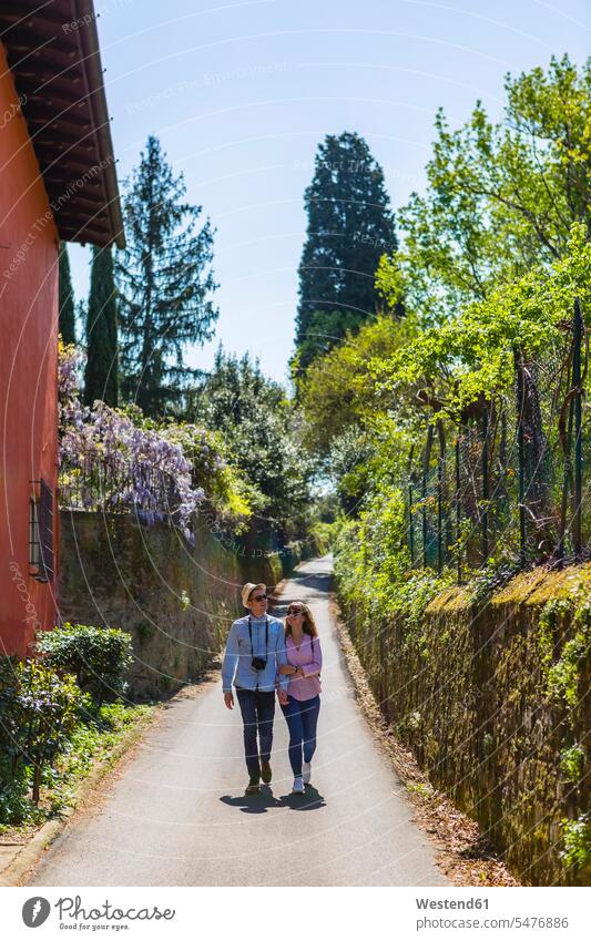 Affectionate couple strolling through narrow alleys in Florence, Tuscany, Italy female tourist City Break City Trip Urban Tourism togetherness face to face